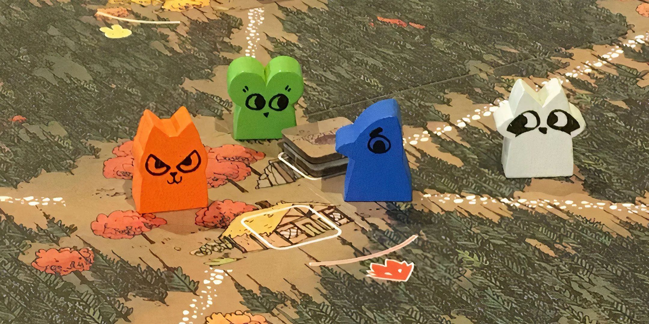 Bốn meeples hình thú rừng trên bản đồ game Root.