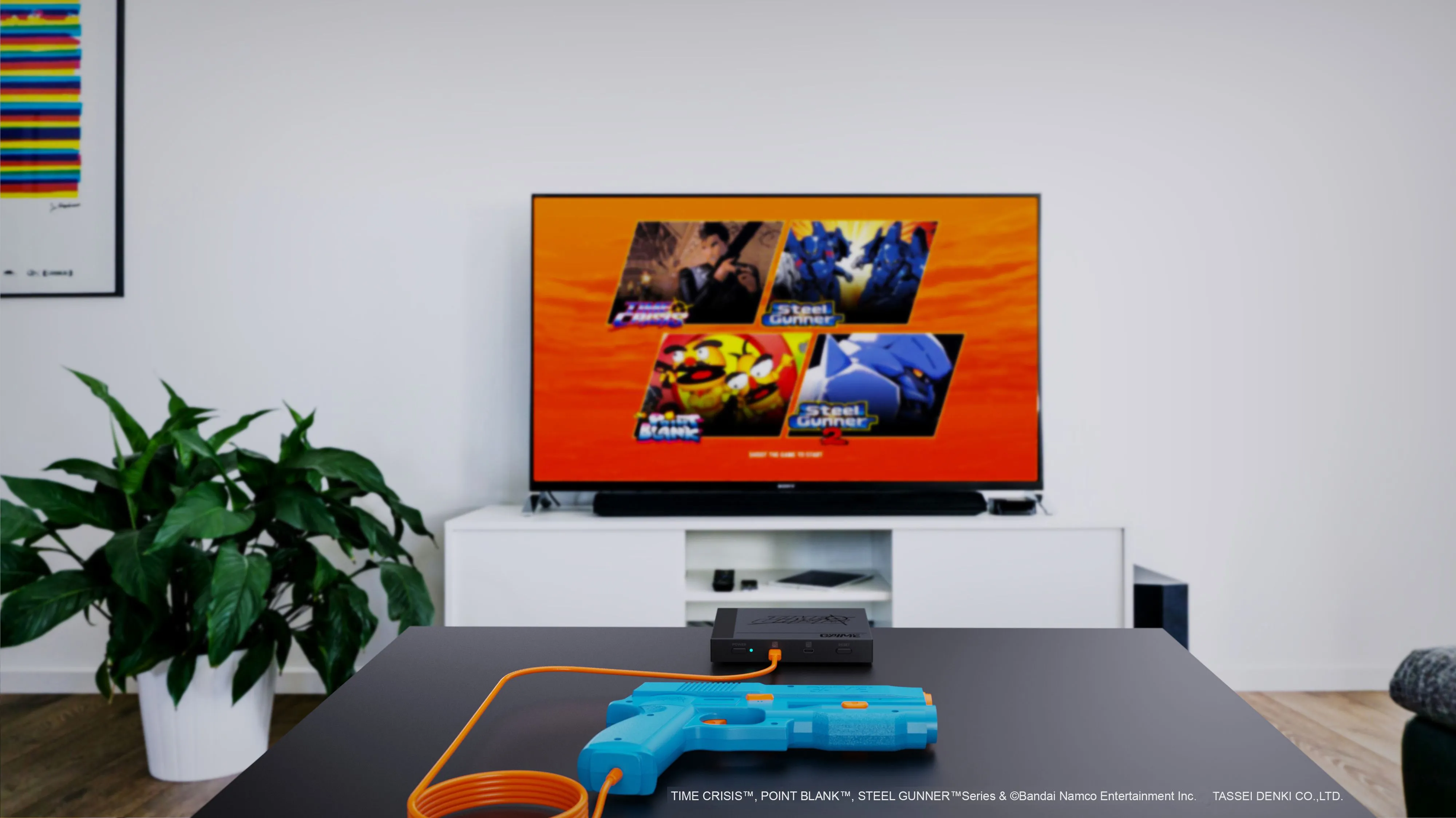 Hệ thống súng light gun G'aim'e Plug & Play đặt trước màn hình TV hiện đại.