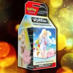 Hộp Premium Tournament Collection Lillie với hình ảnh cô gái tóc vàng Lillie và Pokémon Cosmog đáng yêu.